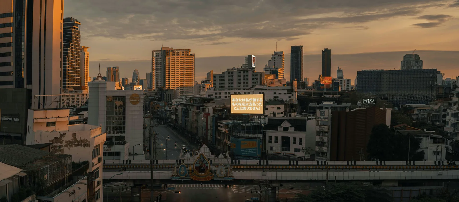 Bangkok buildings, transport routes and advertising screens at sunset