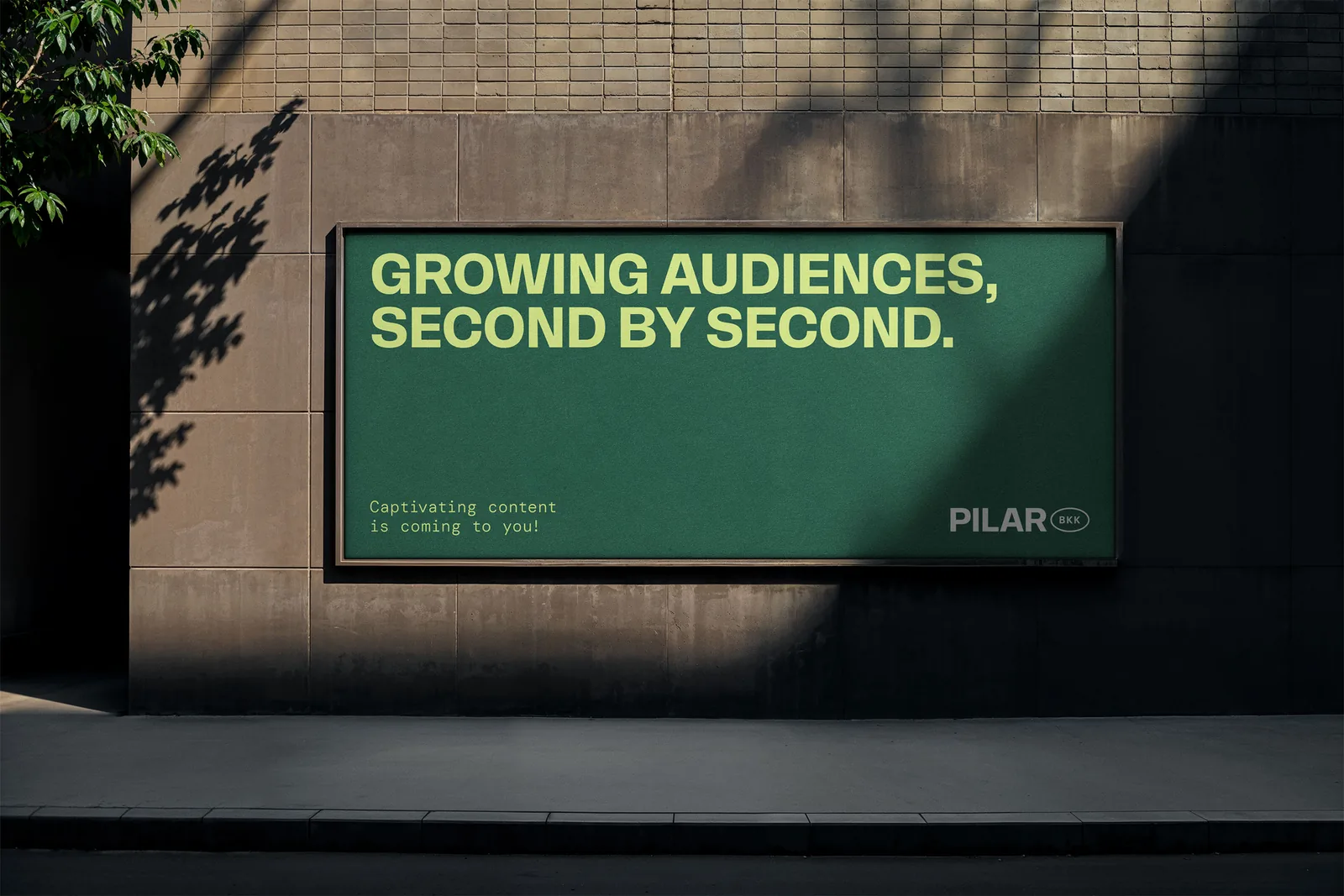 Forest-green and lime Pilar BKK poster concept on a city wall
